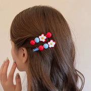 Daisy flower beaded hair clips worn on the side of brown wavy hair