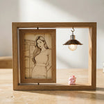 Square wooden picture frame displayed on tabletop with a sketch-style wood carved portrait