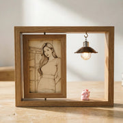 Square wooden picture frame displayed on tabletop with a sketch-style wood carved portrait