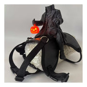 Leather style saddle with realistic headless rider figurine holding a pumpkin