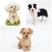 Three small dog figurines or plush toys shown on a white background: a cream poodle-like dog wearing a collar with a blue tag, a black-and-white dog standing with its tongue out, and a tan puppy sitting facing forward.